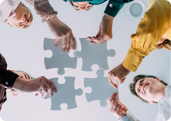 People connecting puzzle pieces overhead