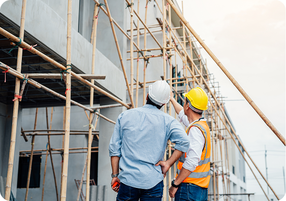 Construction workers inspecting building scaffolding